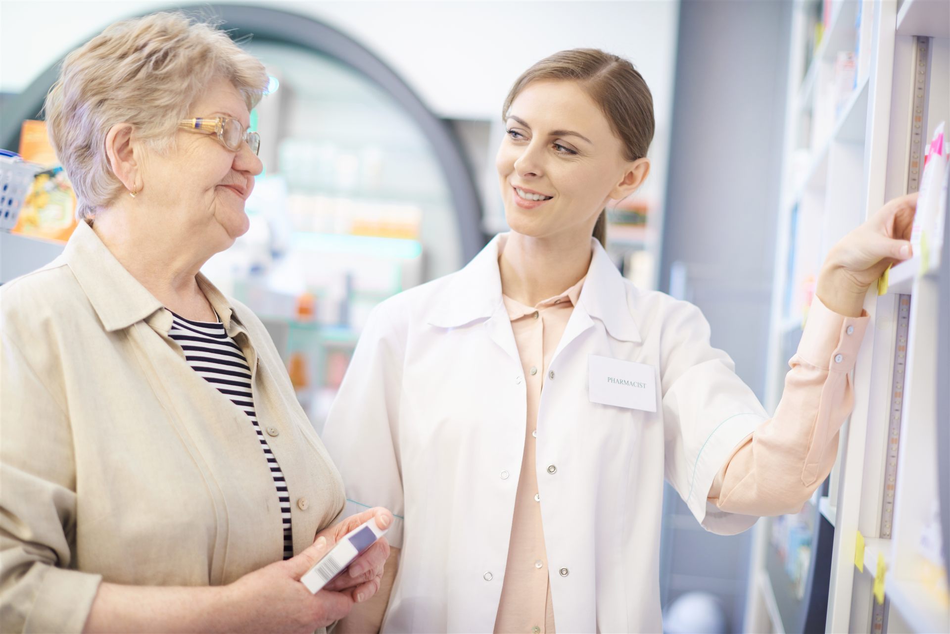 Pharmacist caring for a senior patient